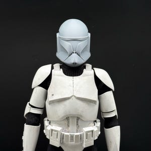 May include: A white ceramic mug with a black handle and the text "But First, Coffee" in a black, bold font. The mug is on a white surface. The mug is approximately 4 inches tall.