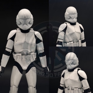 May include: A white plastic action figure of a Star Wars clone trooper. The figure is wearing a white helmet with a visor, a white chest plate, and white armour. The figure is standing on a black background.