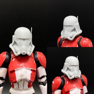 Può includere: Due elmetti di clone trooper di Star Wars in plastica bianca. Gli elmetti hanno un design dipinto di rosso e bianco. Gli elmetti sono su una figura dipinta di rosso e bianco.