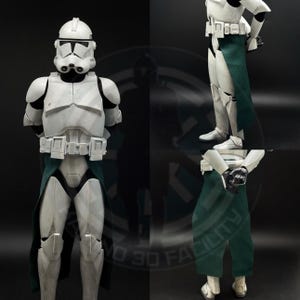May include: A white and gray clone trooper armor with a green fabric skirt. The armor has a helmet, chest plate, and leg coverings. The image shows the front and side views of the costume.