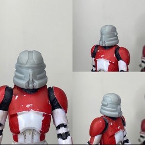May include: A gray plastic helmet with a red and white chest plate. The helmet has a visor and a design on the front. The chest plate has a red and white design.