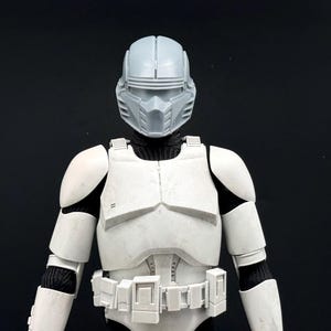 May include: A set of three ceramic mugs with a speckled, matte finish. The mugs are in shades of cream, light gray, and dark gray. Each mug has a simple, minimalist design, perfect for coffee or tea.