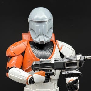 May include: A white ceramic mug with a black handle and the text "But First, Coffee" in a handwritten style. The mug is on a white surface. The mug is 4 inches tall.