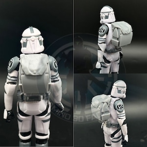 May include: Two white and gray action figures of Star Wars clone troopers with backpacks. The figures are wearing helmets and have a white and gray color scheme. The figures are posed in a standing position.