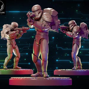 May include: Three figures of futuristic soldiers in combat poses, each holding a weapon. The figures are light gray and stand on circular platforms. The Wardlade Studio logo is in the upper left corner.