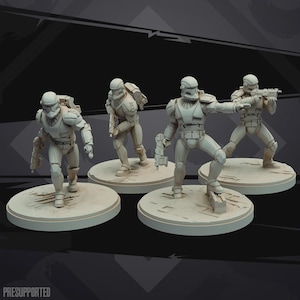 May include: Four unpainted miniature soldier figurines in tactical armor, each standing on a circular base. The figures are posed in dynamic combat stances, holding futuristic blasters. The text "PRESUPPORTED" is visible in the bottom left corner.