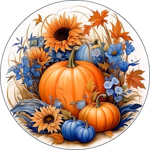 May include: A fall-themed arrangement featuring a large orange pumpkin, smaller pumpkins, and blue gourds. The pumpkins and gourds are surrounded by sunflowers, blue flowers, and green leaves.
