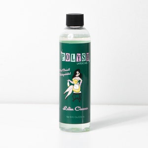 May include: A green bottle of Polysh Latexcare Latex Cleaner. The bottle has a cartoon illustration of a woman in a maid outfit. The bottle is 8 fl oz / 236 ml.