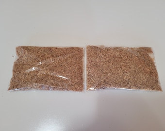 May include: Two clear plastic bags filled with brown wood shavings.