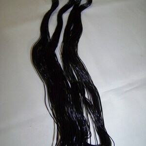 May include: A bundle of black elastic cord, likely used for jewelry making or crafts.