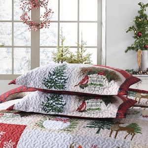 May include: Two white and red Christmas themed pillowcases with a quilted design. The pillowcases feature a green pine tree, red cardinals, and the text "A Wonderful Christmas".