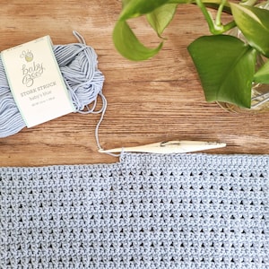 This image is a work in progress photo of this crochet baby blanket pattern, showing the texture of the stitches and the yarn used.