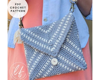 May include: A handmade, light blue crochet bag with a white dotted pattern and a white button closure. The bag has a flap closure and a cream-colored strap with metal clasps. The text "PDF CROCHET PATTERN" is visible in a circle.