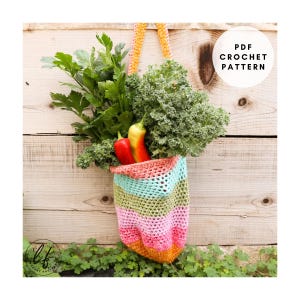 May include: A colorful, crocheted tote bag filled with fresh produce, including kale, parsley, and bell peppers. The bag features horizontal stripes in shades of pink, green, blue, and orange. The text "PDF Crochet Pattern" is visible in a white circle.