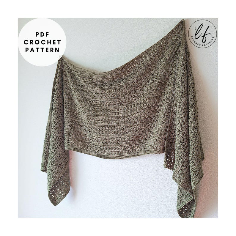 A sage green crochet shawl with a textured pattern and openwork detailing. The shawl is draped against a white wall. The text "PDF CROCHET PATTERN" is in a white circle at the bottom.