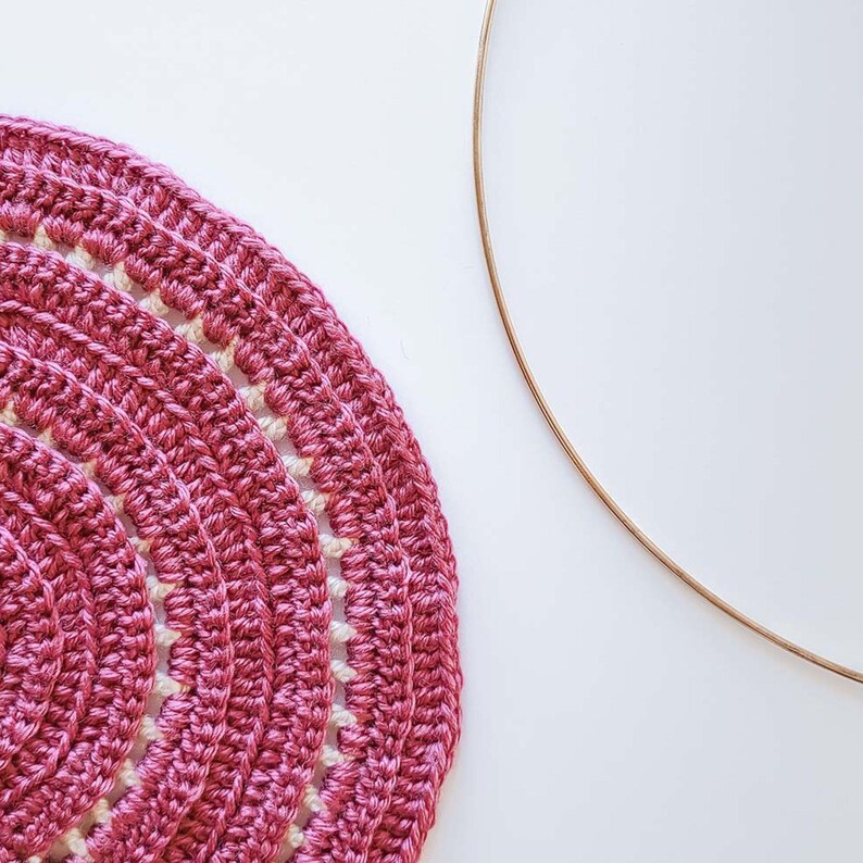 This image is a work in progress photo of this half circle crochet wall hanging pattern, shown before it has been attached to the hoop.