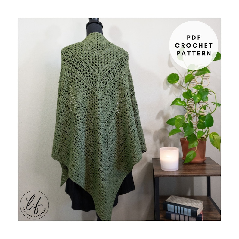 This image shows the crochet triangle shawl pattern sample draped over a mannequin as a woman would wear it. The crochet shawl is shown from the back to show details. The crochet wrap is made in olive green yarn.