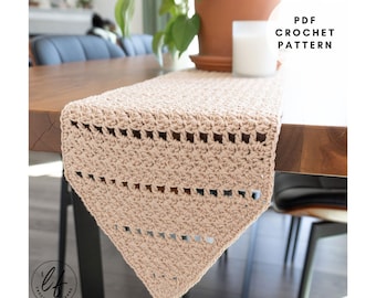 May include: A beige crochet table runner with a textured pattern and openwork design. The runner is displayed on a wooden table. The text "PDF CROCHET PATTERN" is visible in the upper right corner.