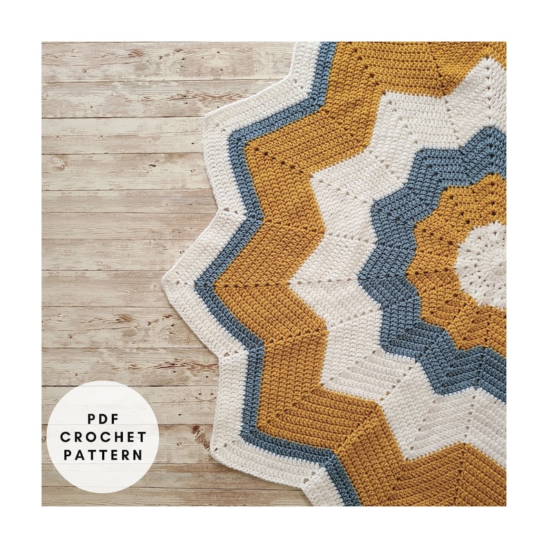 A PDF crochet pattern for a star-shaped blanket in shades of mustard yellow, white, and blue.
