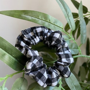 May include: Black and white gingham scrunchie hair tie.