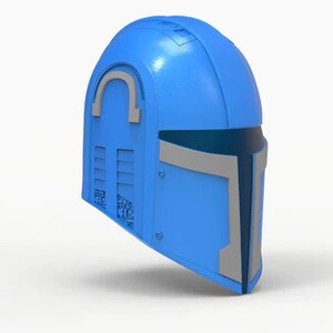 May include: A blue helmet with a gray visor and a silver accent on the top. The helmet has a textured surface and a design on the side.