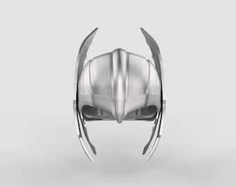 May include: A silver helmet with wings on the sides. The helmet is made of metal and has a smooth, shiny finish.
