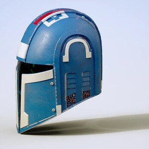 May include: A blue and white helmet with a visor and a series of rectangular vents on the side. The helmet has a white stripe with red accents on the top.
