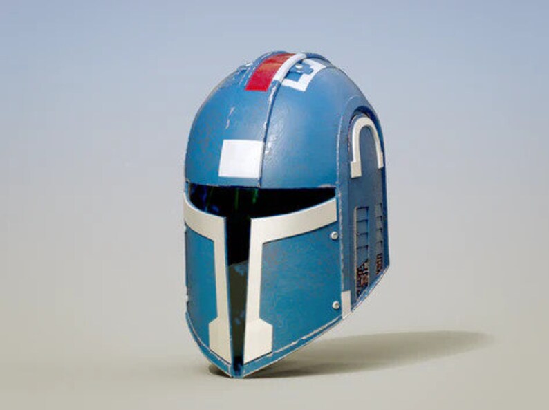 May include: A blue helmet with white and red accents. The helmet has a visor and a textured surface.