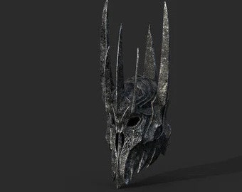 May include: A silver and black metal crown with a skull-like face and sharp points. The crown is detailed with intricate carvings and appears to be made of a heavy metal.