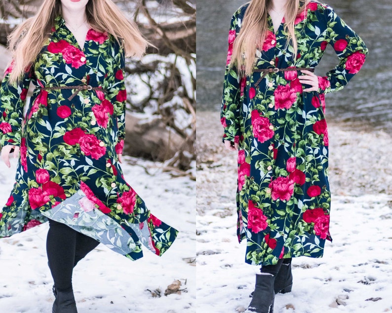 May include: A long-sleeved floral dress with a button-up front and a belt. The dress has a dark blue background with large red and pink flowers. The model is wearing the dress with black leggings and black boots.