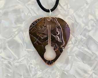 Plectrum, Keychain,  pendant with guitar silhouette cut into it, made from a vintage British penny