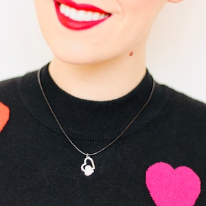 A lucky Sixpence Pendant in a lovely 2 hearts design, hung on a beautiful delicate Silver chain.