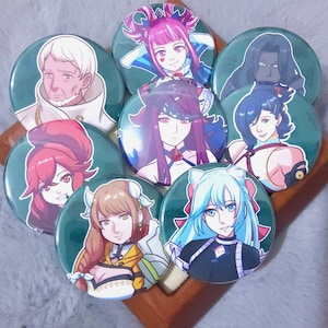 May include: Set of nine round button pins featuring anime characters with various hairstyles and clothing. The pins have a green background and feature characters with different colored hair, including red, pink, blue, and black.