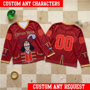 May include: Two long-sleeve jerseys in deep red with gold trim. The front features a graphic of Captain Hook and the text "CAPTAIN HOOK". The back displays the text "YOUR NAME" above the number "00" in large red font with gold outlines.