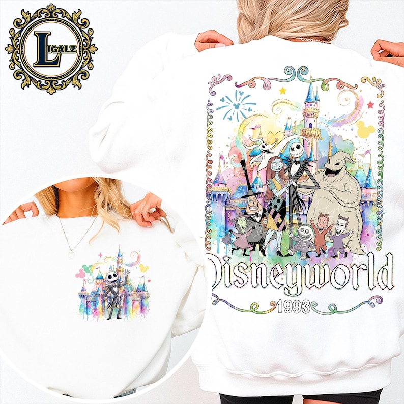 Puede incluir: Sudadera blanca con un gr&aacute;fico colorido de personajes de The Nightmare Before Christmas frente a un castillo. Tambi&eacute;n se muestra el texto "Disneyworld 1993". La sudadera tiene cuello redondo.
