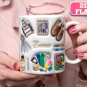 May include: A white ceramic mug featuring raised 2D flat-style illustrations of physical therapy tools, including a hand exerciser, goniometer, therapy oil, measuring tape, and a box of pens. The name Emma is printed in gold script in the center.