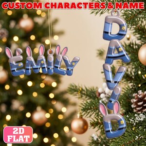 May include: Two custom Christmas ornaments shaped like letters spelling the names EMILY and DAVID. The letters feature a blue and grey police uniform pattern with small gold badges and pink-lined bunny ears attached to the top of the letters.