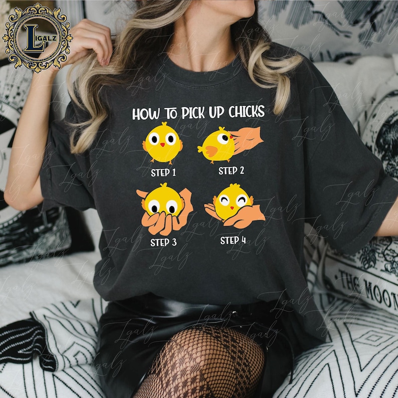 May include: Dark gray t-shirt with the text "HOW TO PICK UP CHICKS" and a four-step graphic of a yellow chick being picked up. The graphic shows the chick in different poses, with the steps labeled 1 through 4.