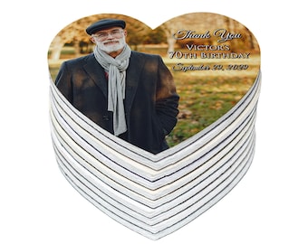 May include: A stack of heart-shaped thank you magnets with a photo of a man in a hat and scarf. The text on the magnet reads "Thank You Victor's 70th Birthday September 29, 2022".