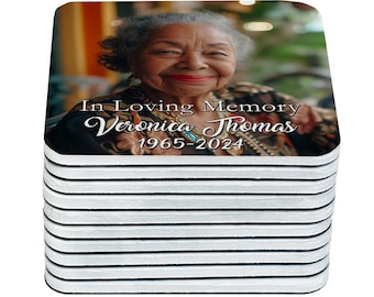 May include: A stack of 12 white coasters with black trim, featuring a photo of a woman with the text "In Loving Memory Veronica Thomas 1965-2024".