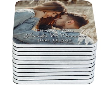 May include: A stack of square coasters featuring a photograph of a couple. The image includes the text "THANK YOU Jennifer & Cameron JUNE 30, 2029". The coasters have a white and black striped edge.