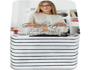 May include: A stack of white coasters with a photo of a woman wearing glasses and a white shirt. The text on the coaster reads "Graduation Destiny FLINN HIGH SCHOOL CLASS OF 2029".