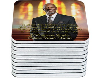 May include: A stack of square coasters. The top coaster features a photo of a smiling man in a suit with text that reads, "To all my dear brothers and sisters...Pastor Noah Walsh."