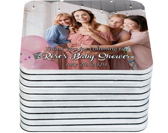 May include: A stack of 12 white coasters with a pink and white design. The top coaster features a photo of four women, two pink balloons, and the text "Thank you for coming to Rose's Baby Shower July 28, 2029".