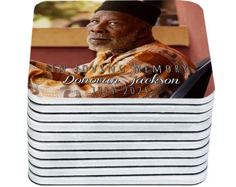 May include: A stack of 10 square coasters with a photo of a man on the top coaster. The photo shows a man with a beard and a hat, wearing a patterned shirt. The text "IN LOVING MEMORY Donovan Jackson 1944-2024" is printed on the coaster.