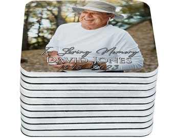 May include: A stack of 12 square coasters with a photo of a man in a hat and the text "In Loving Memory DAVID JONES 1948-2023".