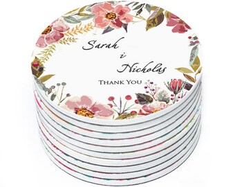May include: A stack of round, white coasters with a floral design and the text "Sarah & Nicholas Thank You".