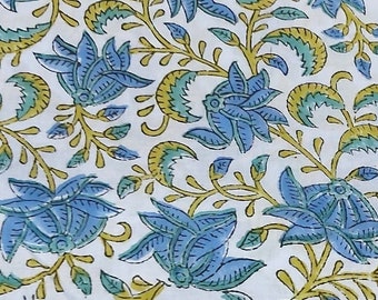 May include: Blue and green floral print fabric. The fabric has a white background with a repeating pattern of blue flowers and green leaves.
