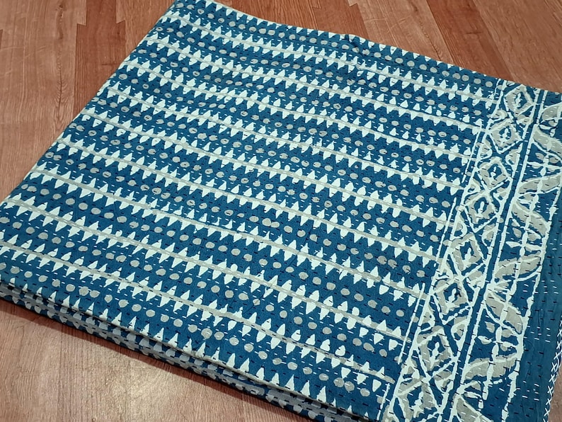 Puede incluir: Una tela de algod&oacute;n azul y blanco con un patr&oacute;n geom&eacute;trico. La tela tiene un borde con un dise&ntilde;o m&aacute;s intrincado.