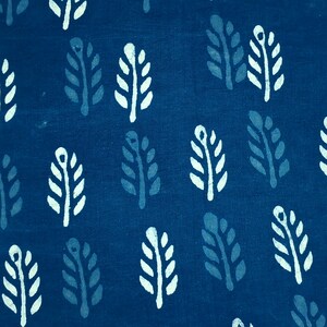May include: A blue fabric with a white and blue leaf pattern. The leaves are arranged in a repeating pattern.